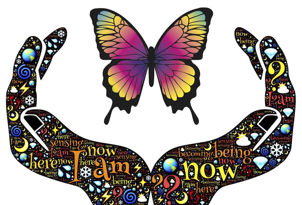 Open hands covered with spirit symbols and holding a butterfly
